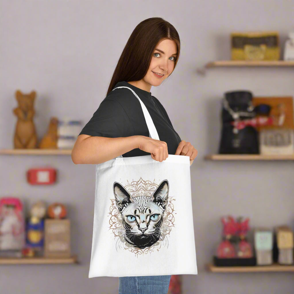 Woman holding a tote bag with a sphynx cat design 