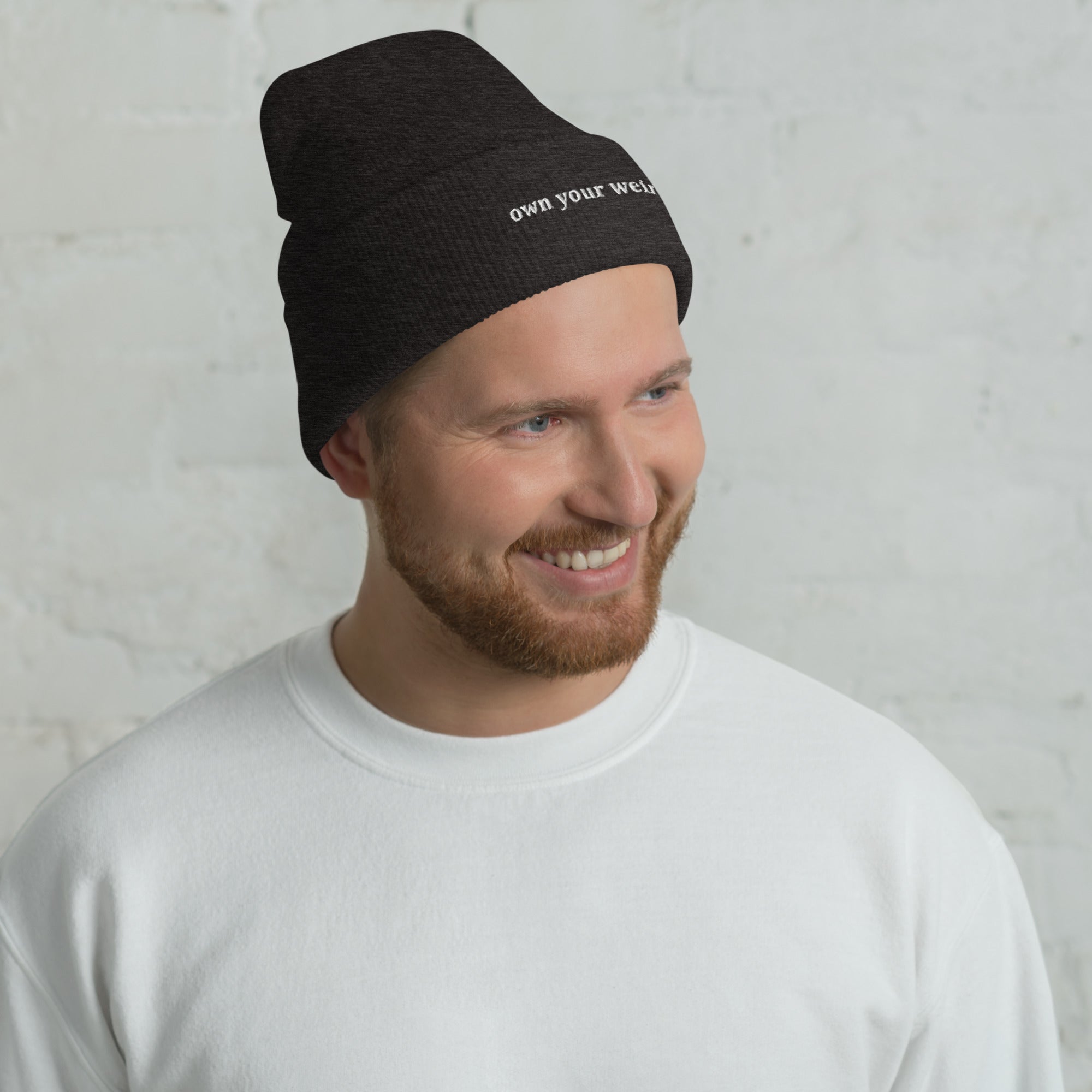 Man wearing Own Your Weird embroidered beanie from Nyxhera Creations, minimalist winter look