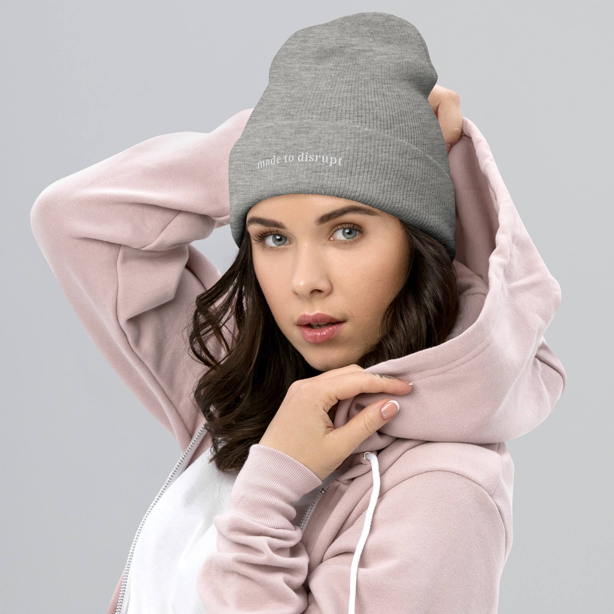 person wearing Made to Disrupt embroidered light grey beanie from Nyxhera Creations, minimalist winter outfit