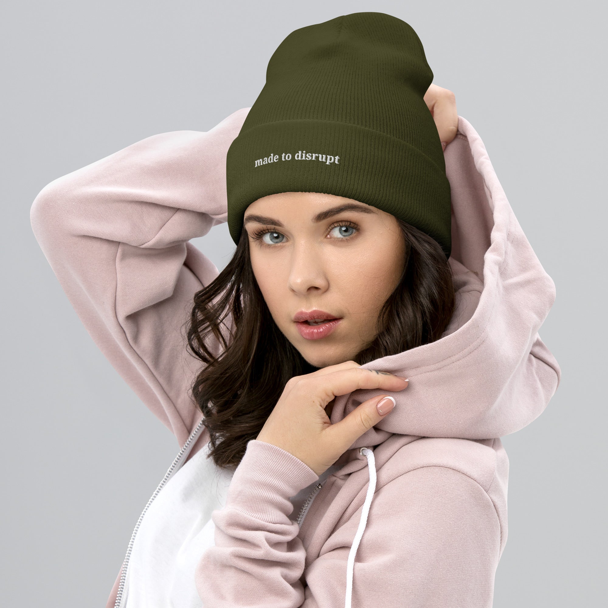 Woman wearing Made to Disrupt embroidered olive beanie from Nyxhera Creations, minimalist winter outfit