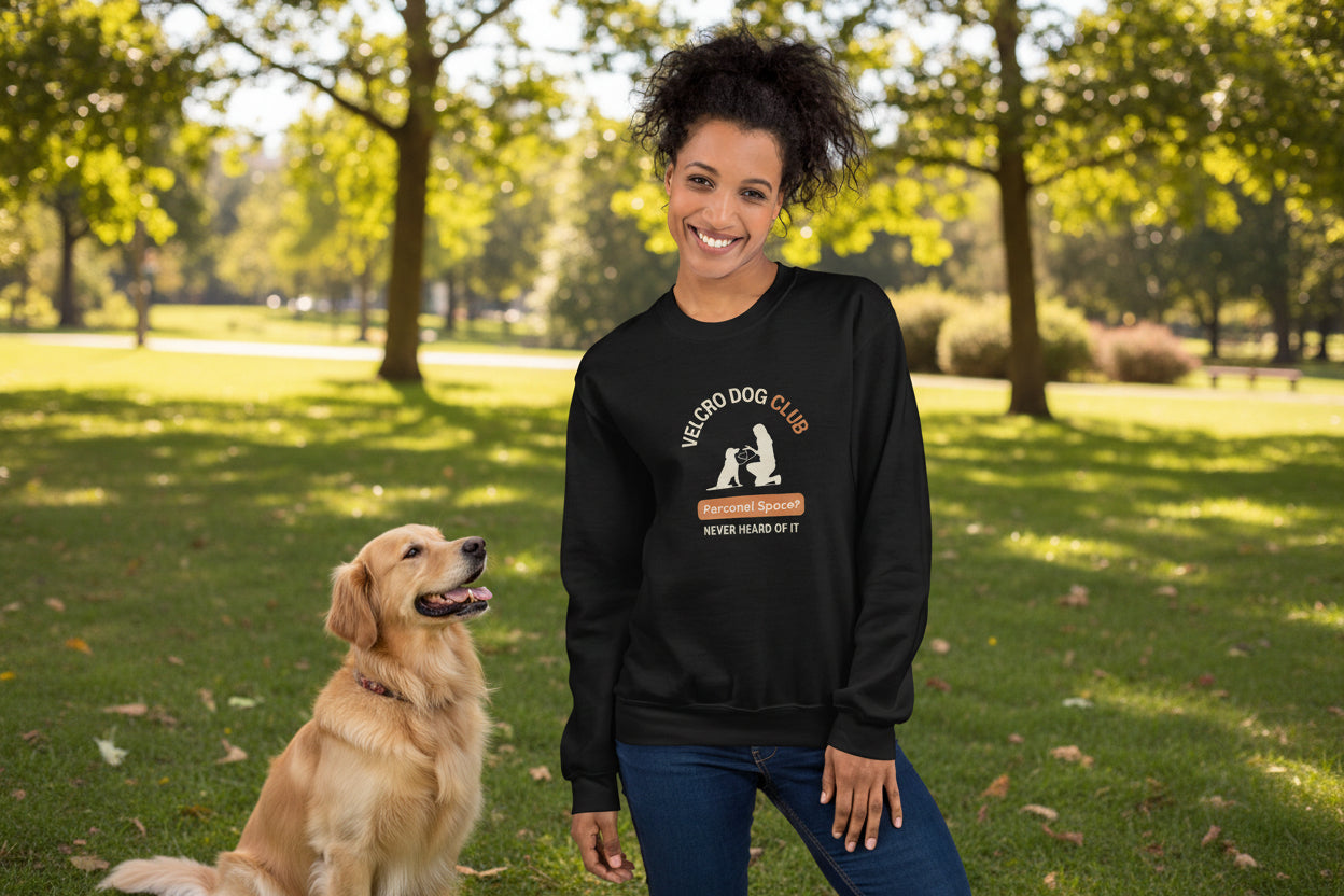Person wearing a black sweatshirt with 'Velcro Dog Club' design, standing against a plain background.