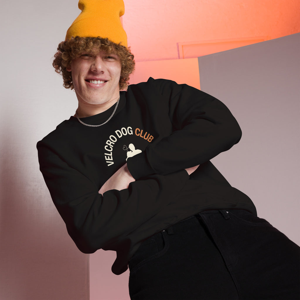Person wearing a black 'Velcro Dog Club' sweatshirt