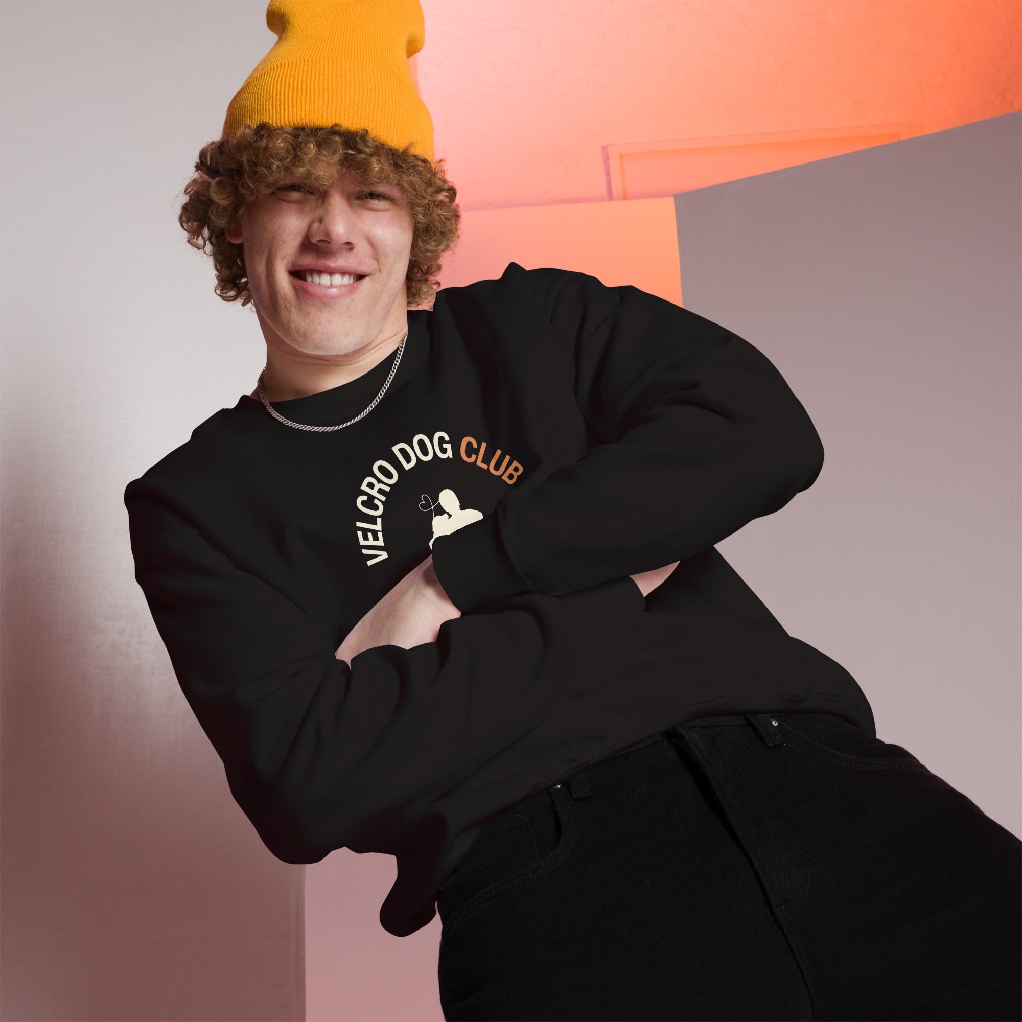 Person wearing a black 'Velcro Dog Club' sweatshirt