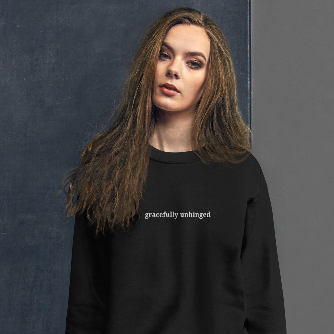 woman wearing Gracefully Unhinged embroidered sweatshirt from Nyxhera Creations, casual minimalist style