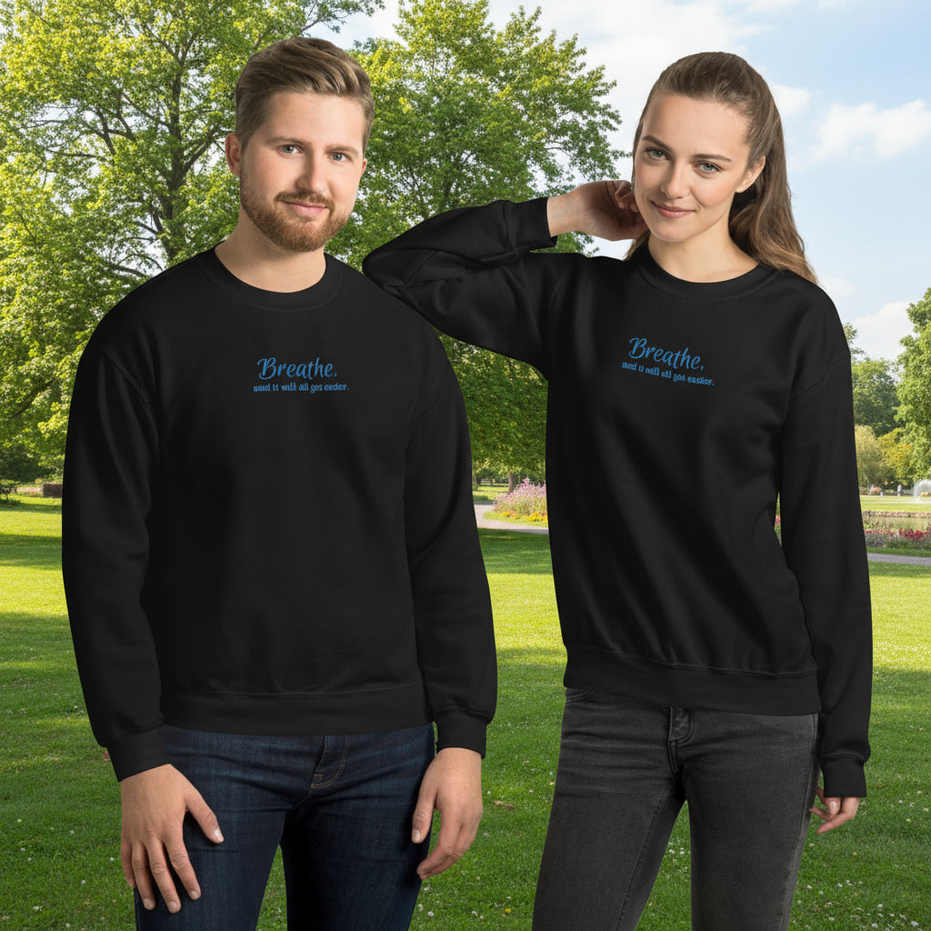 Male and female models wearing the “Breathe and It Will All Get Easier” embroidered black sweatshirt, styled for everyday comfort and mindfulness.