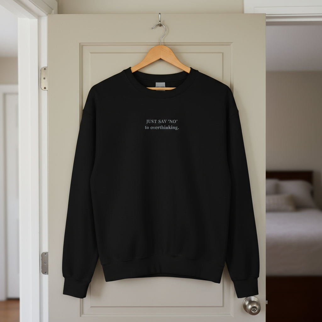 black sweatshirt with embroidered text "Just say 'no' to overthinking" in grey thread