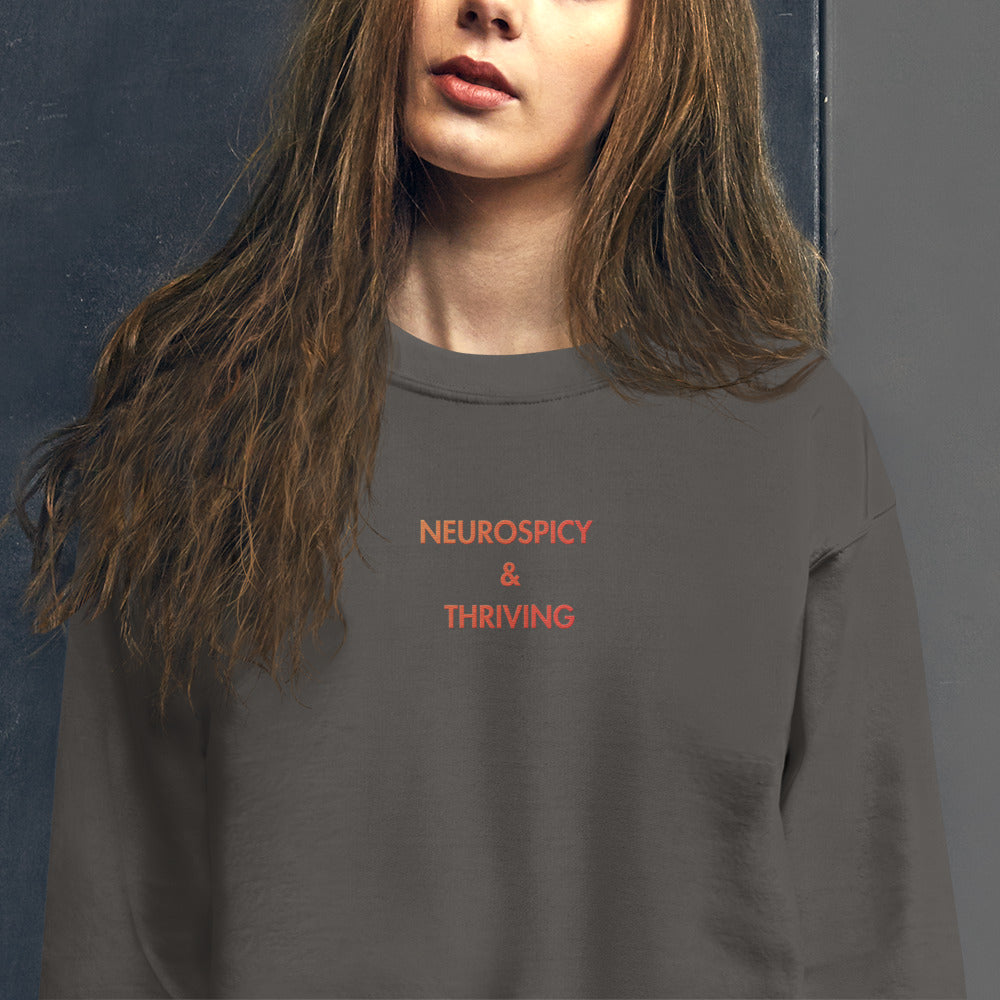 person wearing Neurospicy and Thriving sweatshirt from Nyxhera Creations, minimalist casual outfit