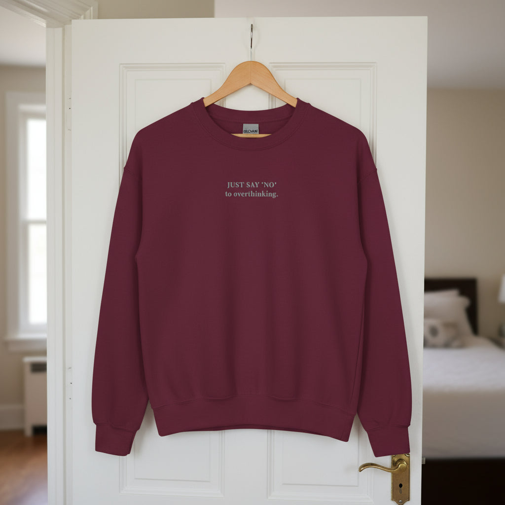 maroon sweatshirt with embroidered text "Just say 'no' to overthinking" in grey thread