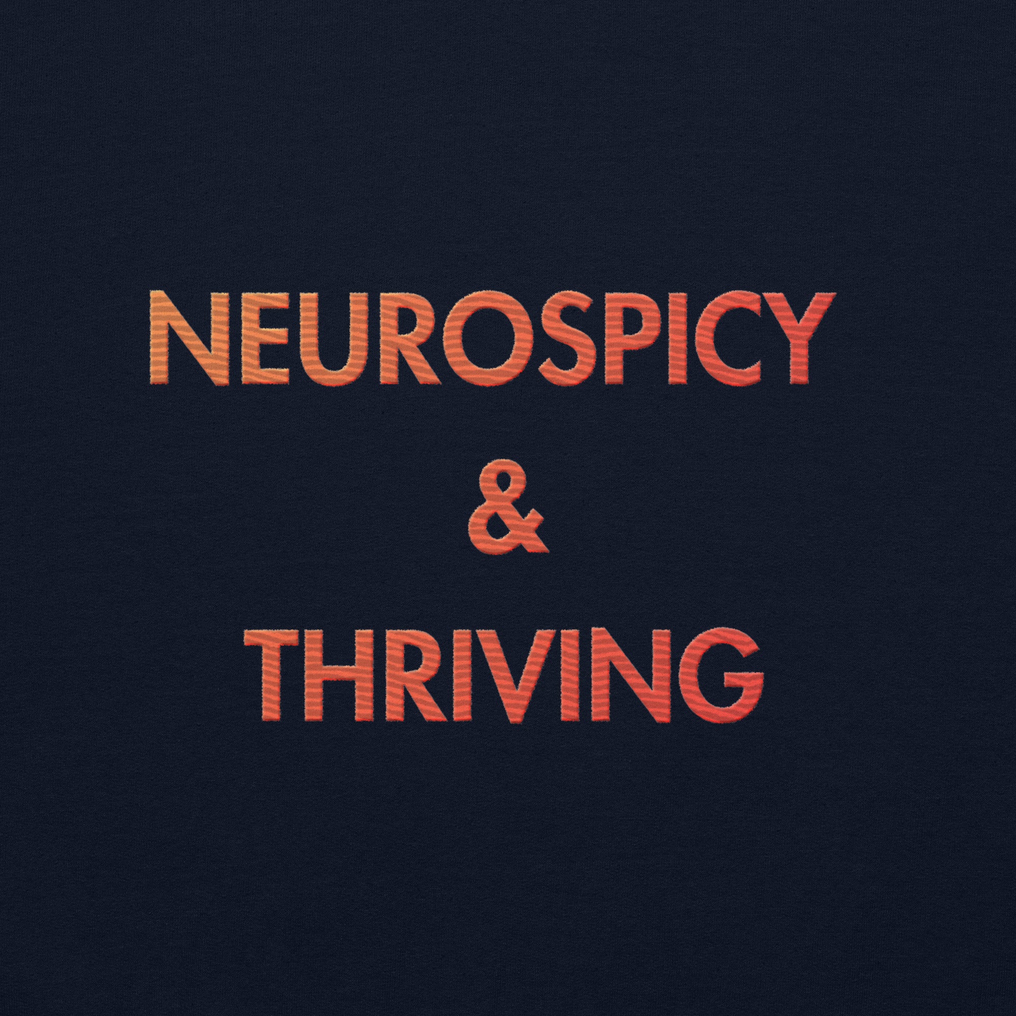 close up detailed red-to-orange gradient embroidery reading Neurospicy and Thriving 