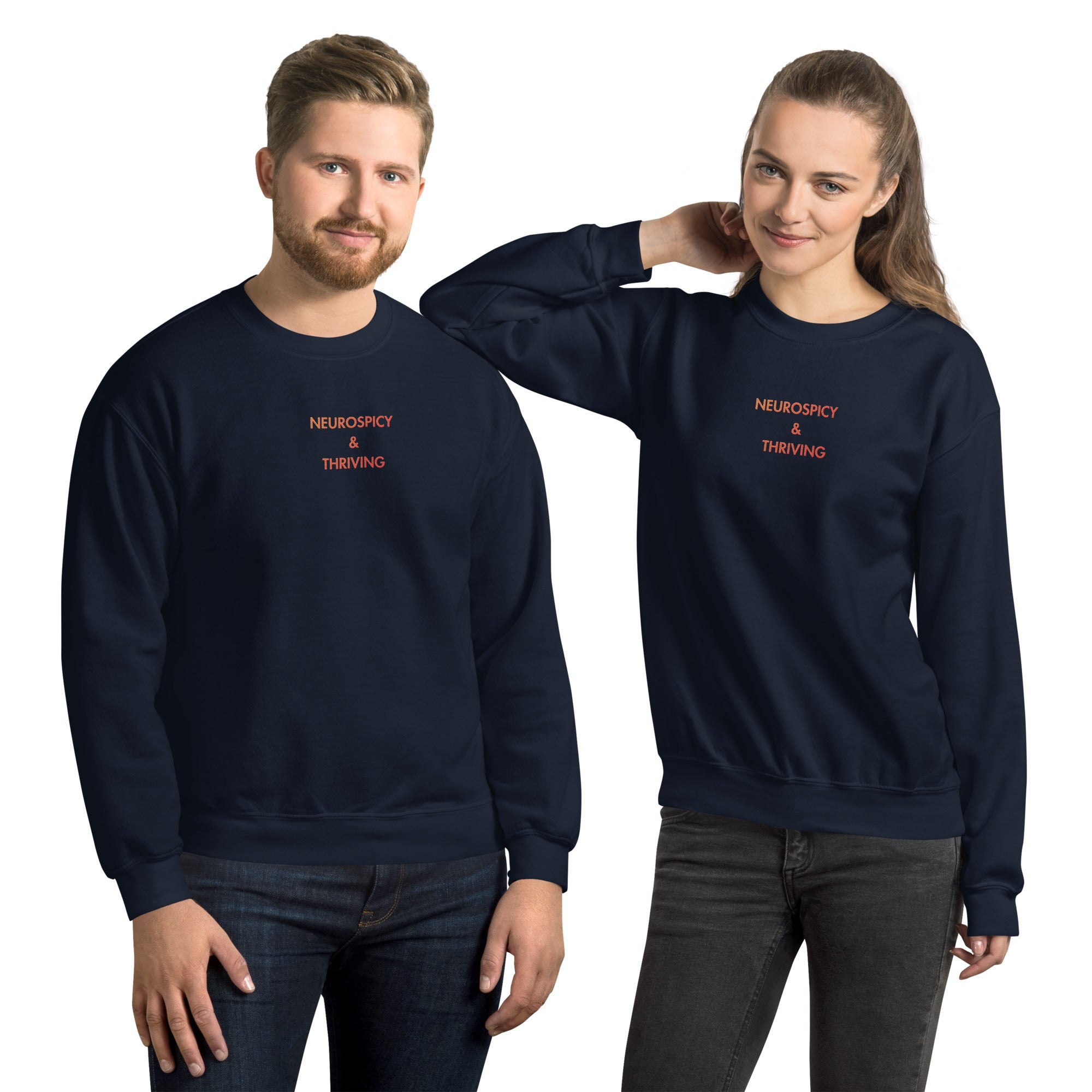 Man and woman wearing Neurospicy and Thriving embroidered sweatshirt by Nyxhera Creations, navy Gildan crewneck with red-to-orange gradient centre-chest embroidery
