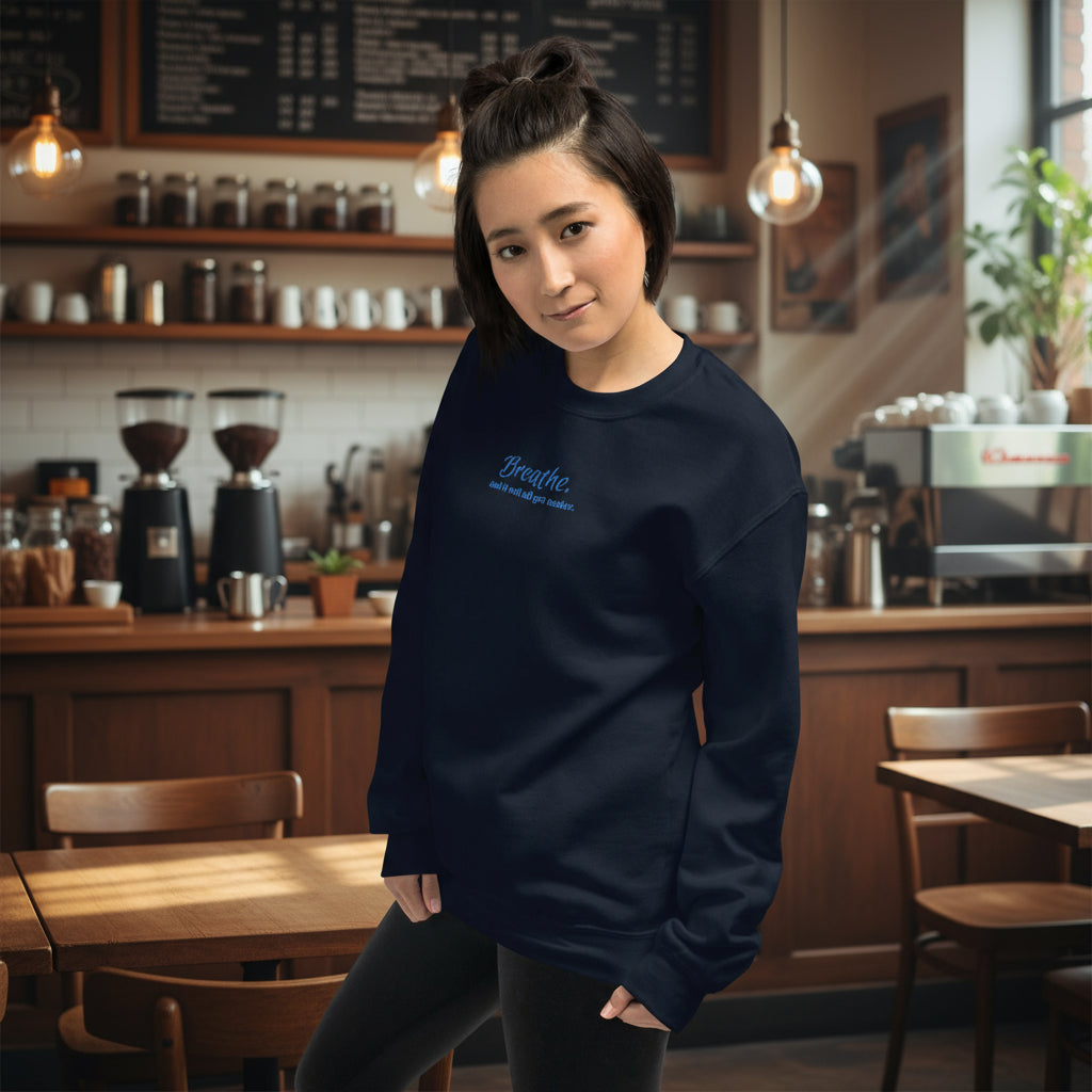 Unisex embroidered sweatshirt in navy featuring quote “Breathe and It Will All Get Easier” stitched in calming blue thread.