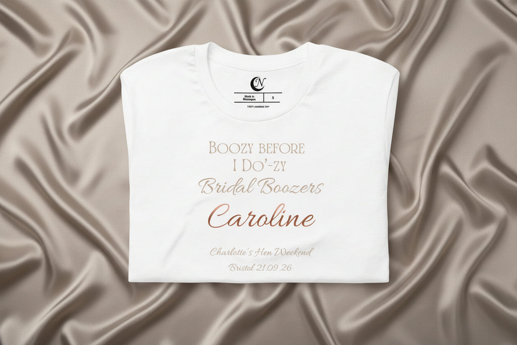 Close-up of personalised name and metallic-effect text on white bridal party hen t-shirt.