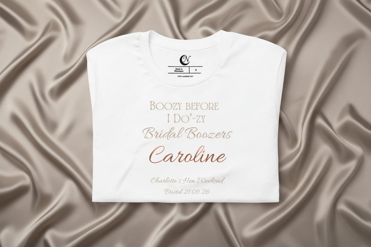 Close-up of personalised name and metallic-effect text on white bridal party hen t-shirt.
