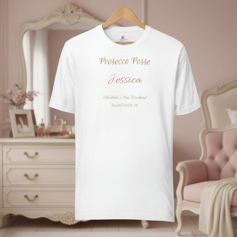 White t-shirt with 'Prosecco Posse' and personalised party member name text on a hanger in a room with furniture and decor.
