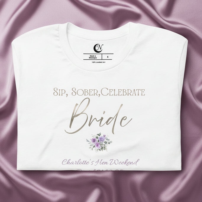 Close-up of floral graphic and metallic-effect bride text on white sober hen party t-shirt.