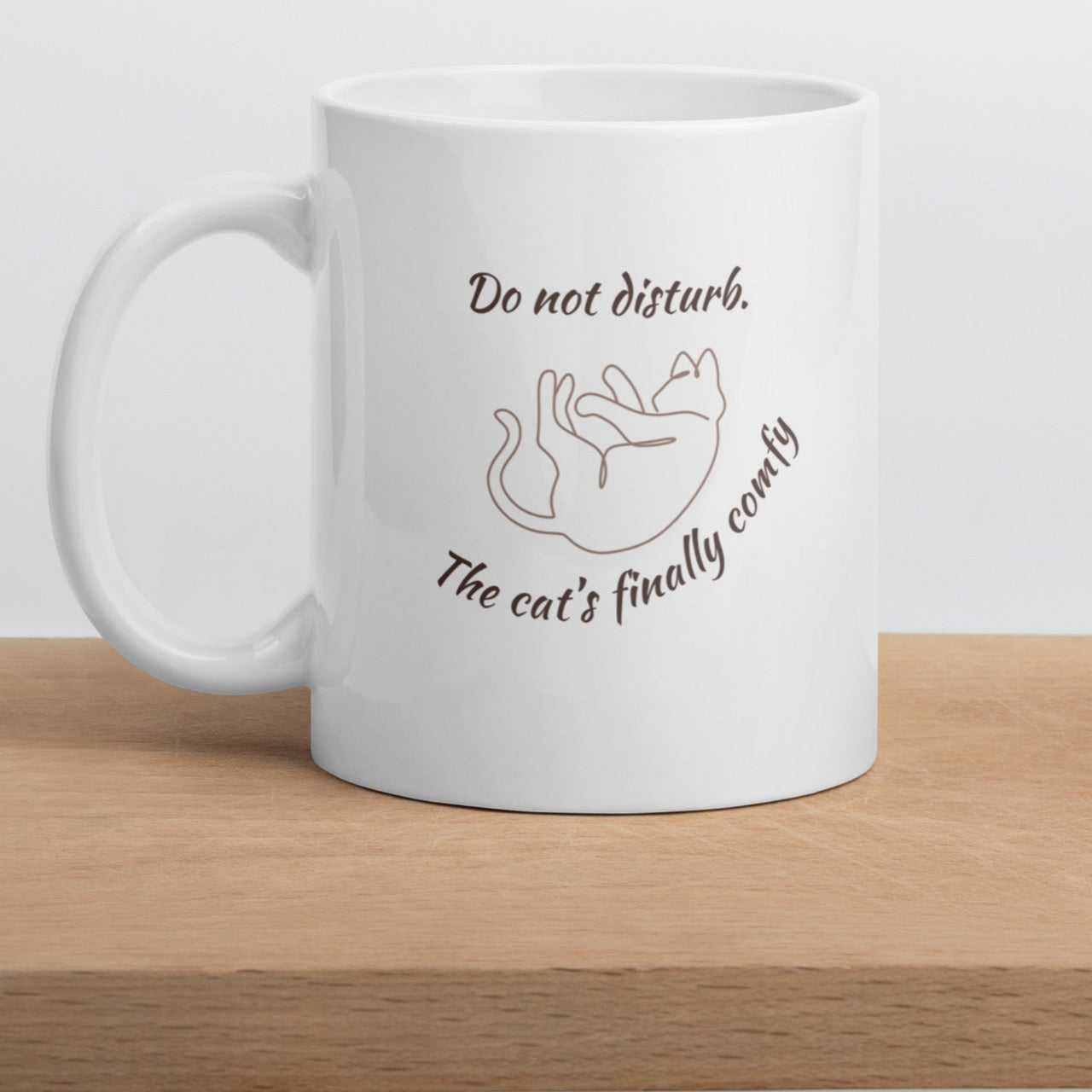 Close-up of line-art cat illustration on ceramic mug