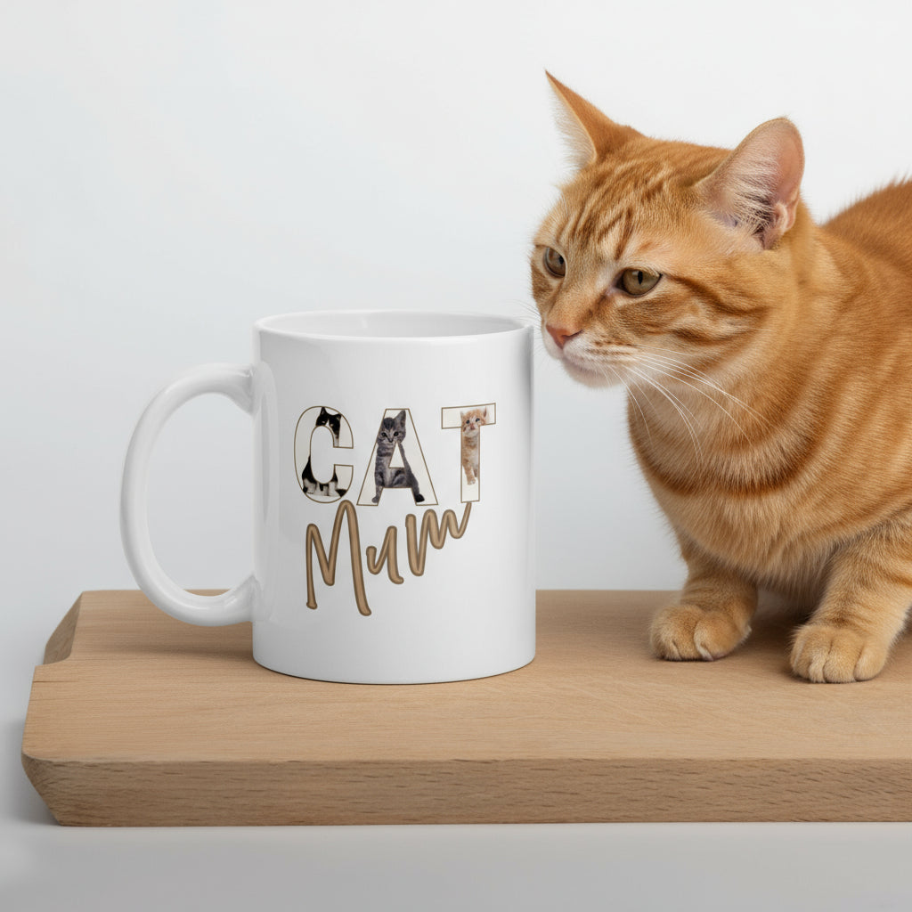 White ceramic 11oz mug with ‘CAT’ letters illustrated with playful cat designs