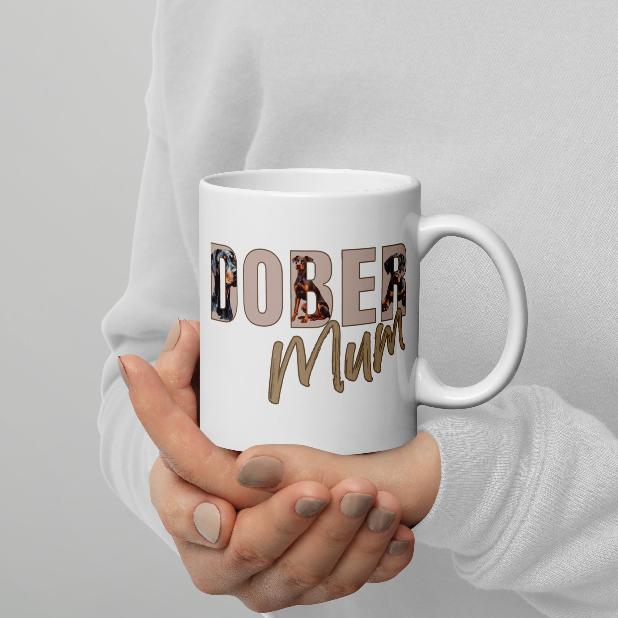 Close up White ceramic mug with “Dober Mum” letters filled with Doberman illustrations, 11oz size