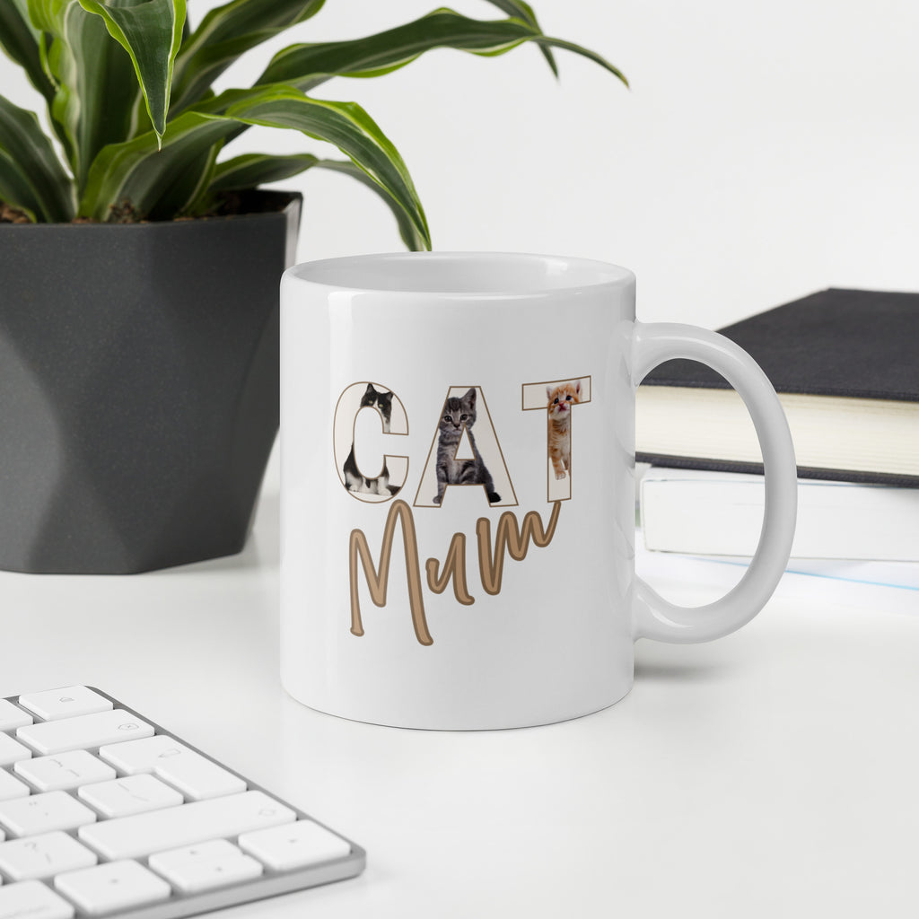 White ceramic 11oz mug with ‘CAT’ letters illustrated with playful cat designs