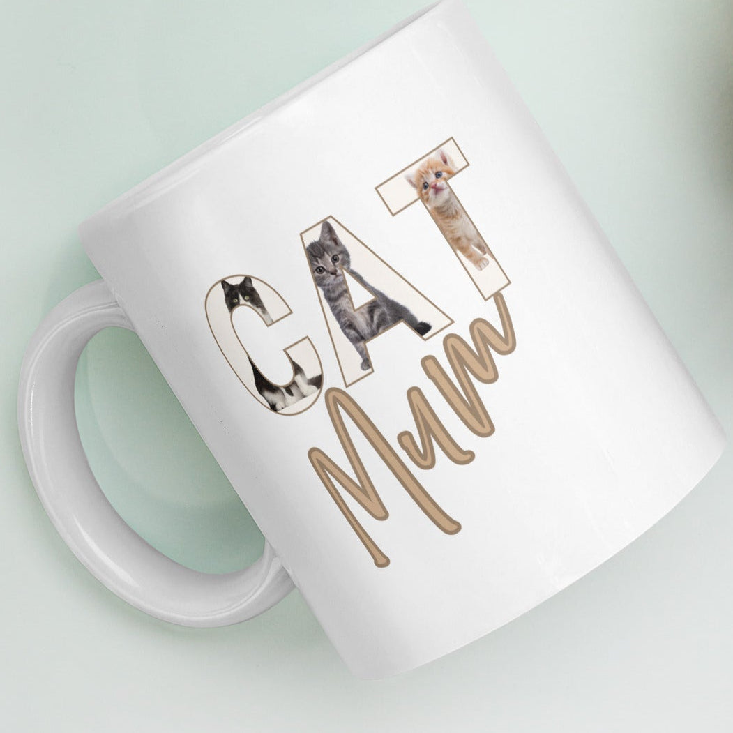 Close-up of illustrated cats in letters forming the word CAT on white 11oz mug