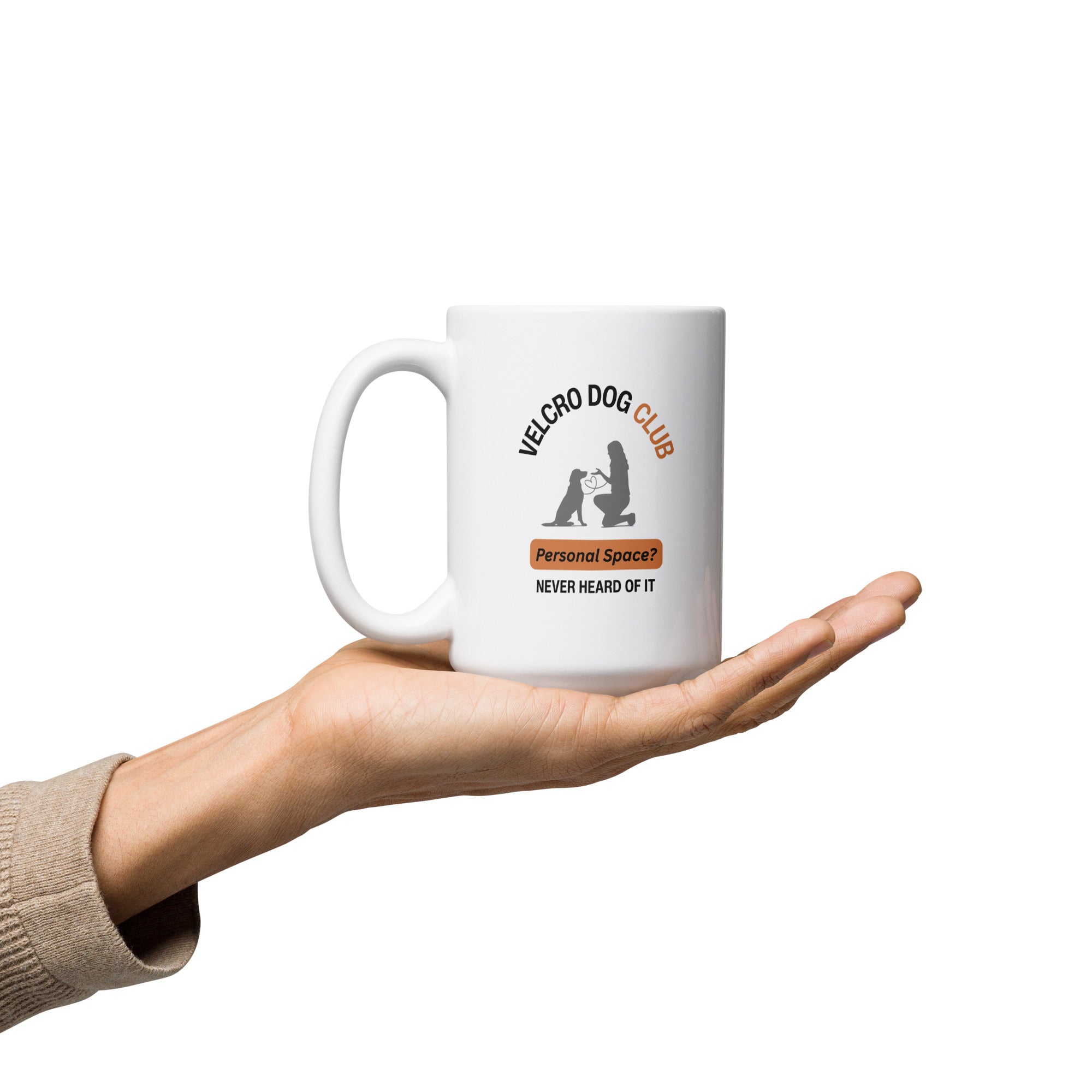 White mug with Velcro Dog Club design held in a hand on a white background
