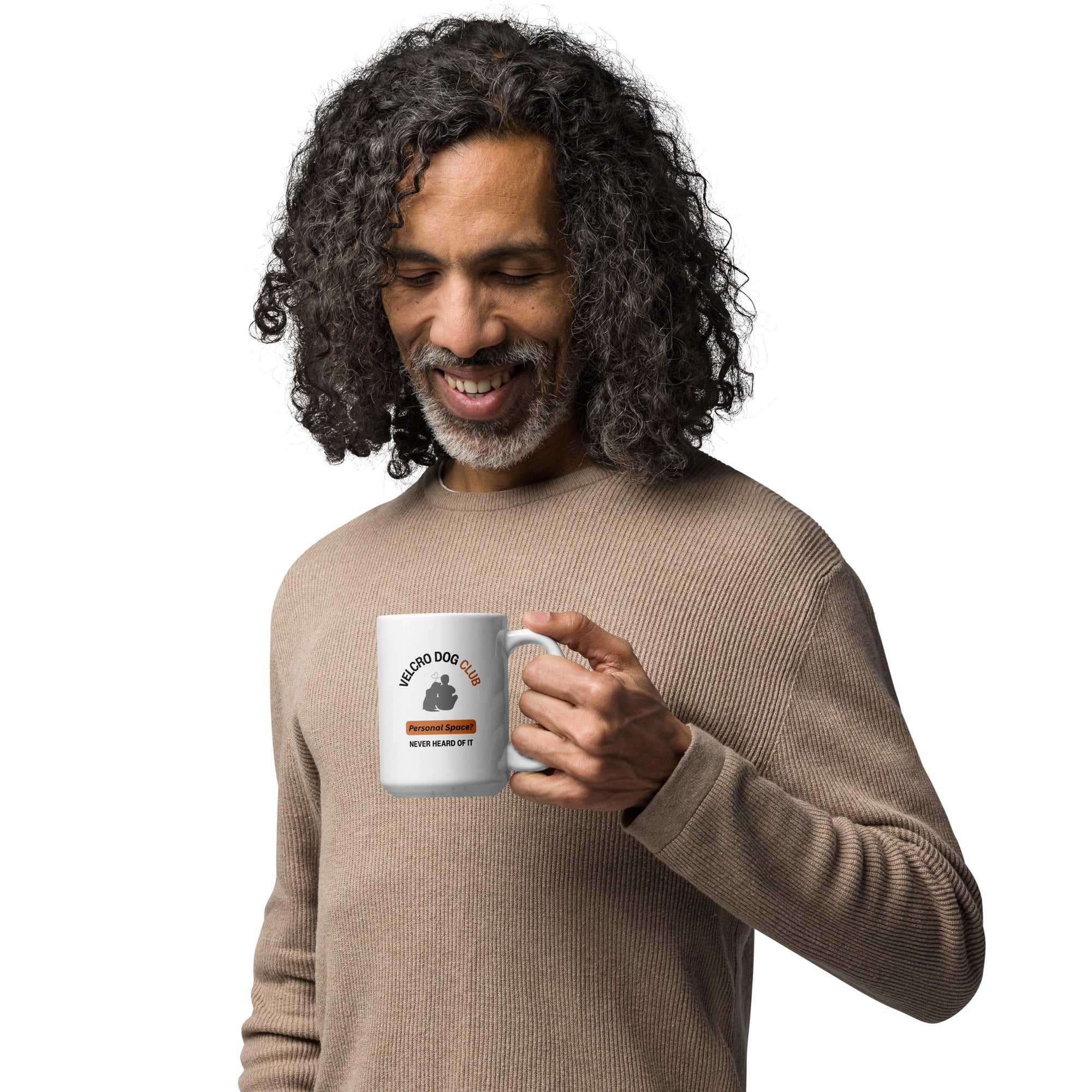 Man holding a mug with Velcro Dog Club design, on a white background